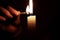 Light candle in darkness with match