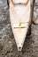 Light-colored fishing canoe resting on the sands of the river