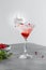Light composition of an alcoholic cocktail with raspberries and martini. Shot with mint and berries.