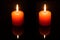 Light couple candle on black background
