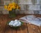 Light dessert. Plate with Bizete cookies for reading a book, a bouquet of dandelions