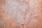 Light dusty orange-pink textured stone interior background with copy space