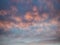 Light evening cumulus clouds in the sky. Colorful cloudy sky at sunset. Sky texture, abstract nature background