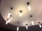 Light fixtures hang at ceiling of building