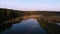 Light fog over lake at sunrise. Misty morning over lake in the forest. Picturesque morning scene