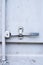 Light gray background. Closed door. Iron lock