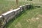 Light gray rough-hewn drystone retaining wall
