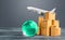 Light green globe near cardboard boxes and freight plane. International delivery of goods and products. Logistics, infrastructure
