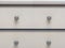 Light grey colored wooden cabinet drawers