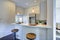 Light grey kitchen room interior with bar style kitchen island