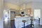 Light grey kitchen room interior with bar style kitchen island