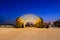 Light illuminated dome at outdoor park with blue and orange sky background