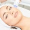 Light infrared therapy. Cosmetology head procedure. Beauty woman face. Cosmetic salon device. Facial skin rejuvenation