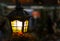 Light lantern street in the dark. Lamp with stained glass windows close-up on a blurred city background