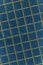 Light lattice or grid on a dark background. Abstract blue and orange vertical backdrop. Inverted squared notebook sheet. Rough