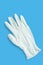 Light medical hygiene glove on a blue background