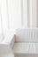 Light minimalist laconic interior with white walls, white sofa,