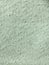 Light mint green textured carpet tile. Textile background.