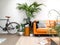 Light modern living room with a brown leather couch and numerous houseplants creating an urban jungle