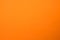 Light orange matte background of suede fabric, closeup. Velvet texture of seamless ginger woolen felt