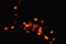 Light orange star light effect isolated overlay glitter texture on black