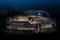 Light painted at night and in very beat up and in poor condition Classic American car from the fifties