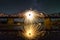 Light painting art concept. Spinning steel wool in abstract circle, firework showers of bright yellow glowing sparkles on long