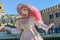 Light pink costumed masked woman