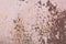 Light pink paint peeling off from the surface of the old metallic texture grunge steel background obsolete messy