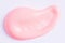 Light pink paint swatch on white paper background. Peach color swatch of lip gloss, cosmetic product stroke gouache, oil paint