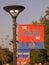 a light pole with banner on the street in front of trees