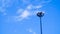 Light pole of floodlight on evening dusk sky background