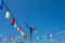 Light poles and lamp with colorful paper on a bright blue sky