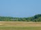 Light private plane is landing on a small airfield on a sunny summer day