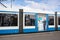 Light rail tram with poster of female worker welcoming passengers on board