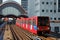 Light railway train approaching the station at Canary Wharf, Lon