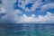 Light rainbow over the ocean, horizon seafront, blue sky and cloudscape