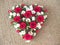 Light red beautiful love flower roses and red hearts and fresh lilac flowers on white