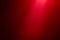 Light red ray of light on a dark red finely textured background