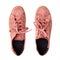 Light red suede sneakers white background isolated close up top view, stylish pink chamois gumshoes, pair of beige leather shoes