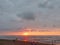 Light red sunset nature paradise tropical island beach and red and purple cloudscape over the sea