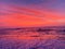 Light red sunset nature paradise tropical island beach and red and purple cloudscape over the sea