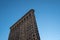 Light reflection on architecture closeup of Flatiron Building in the afternoon in New York City