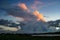 The light of the setting sun illuminates the top of a dramatic looking thunderstorm in Transylvania, Romania