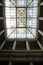 Light shining through antique lead glass window in the roof of an old building in Lima, Peru