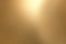 Light shining on rough gold metallic wall surfaces, abstract texture background
