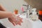 Light-skinned Asian woman washing foamy hands in the bathroom sink with soap.