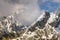 Light smoky cloud entangled between two mountain peaks