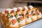 Light snacks in a plate on a buffet table. Assorted mini canapes, delicacies and snacks, restaurant food at event. A gala