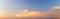 Light soft panorama sunset sky background with clouds illuminated by sun